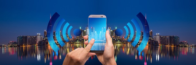 Hands holding a smartphone using WiFi network in a city