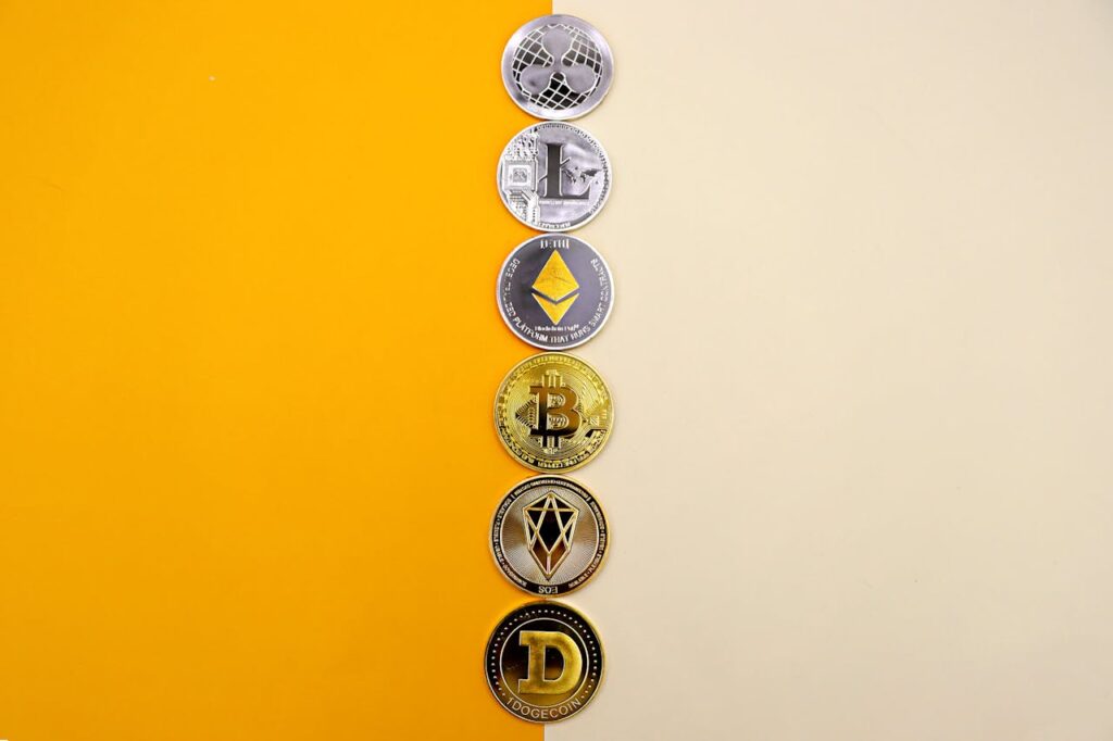 A Line of Cryptocurrency Coins Lying on Yellow and White Background
