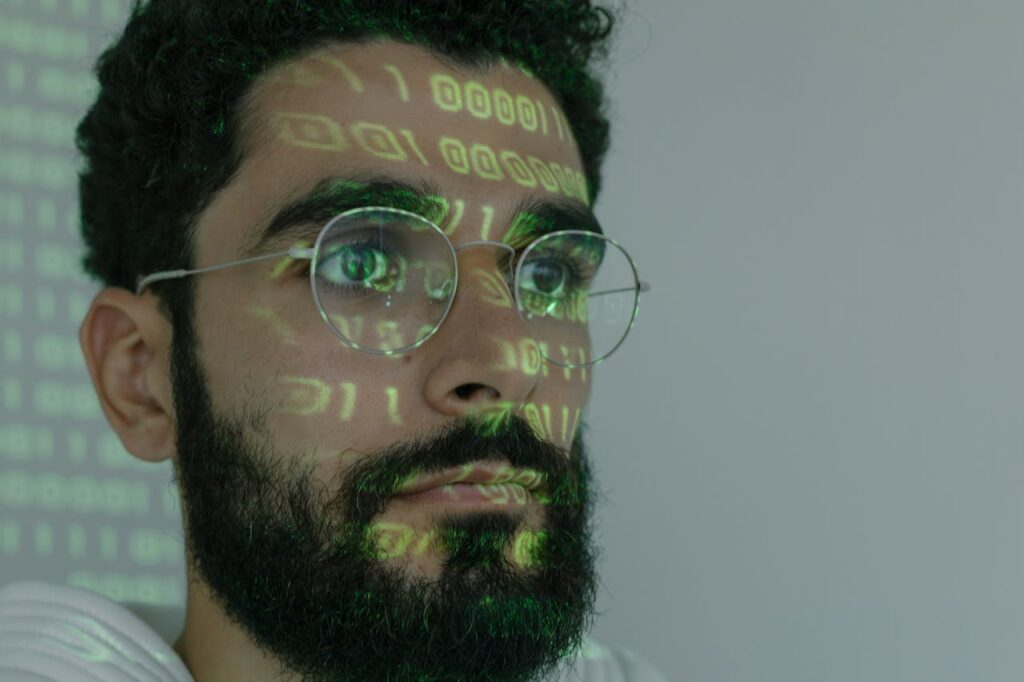 Man in White Crew Neck Shirt Wearing Silver Framed Eyeglasses